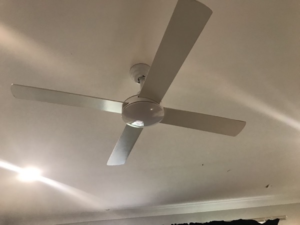 A white ceiling fan on a ceiling