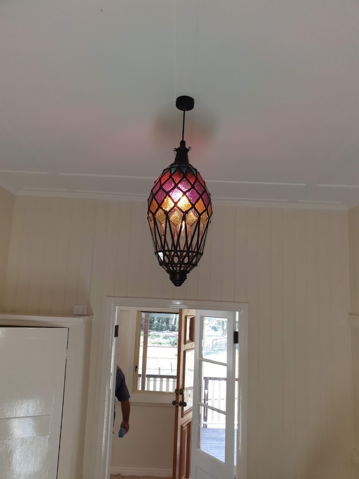 A leadlight pendant light hanging in a hallway